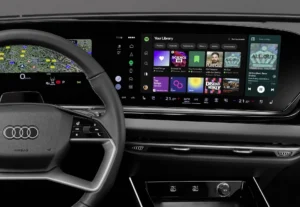 aplicación Spotify en Audi: Pantalla de infotainment Audi con aplicación Spotify y volante.