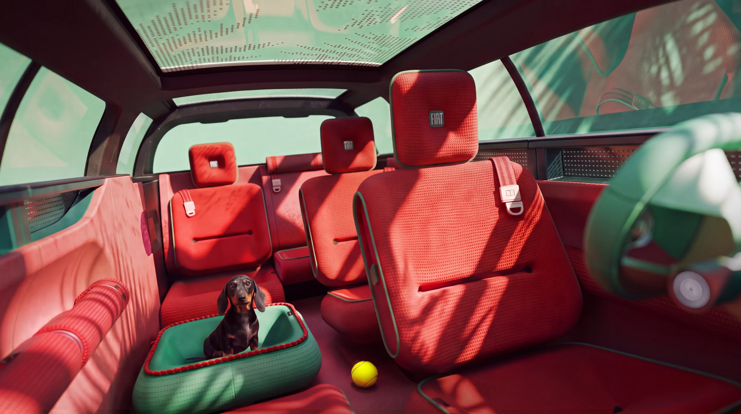 Interior del FIAT Multiplay con asientos rojos y perro salchicha.